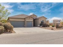 Charming single-story home featuring a three-car garage and well-maintained landscaping at 1085 W Ayrshire Trl, San Tan Valley, AZ 85143