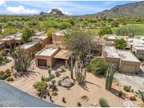 Expansive desert home showcasing native cacti and a tranquil setting near a golf course and mountain backdrop at 1607 N Quartz Valley Rd, Scottsdale, AZ 85266