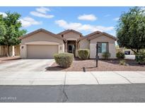 Charming single-story home with a two-car garage, low maintenance yard, and covered porch at 16861 W Ironwood St, Surprise, AZ 85388