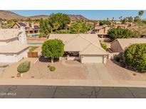 Attractive single-story home with desert landscaping, charming front porch, and convenient attached two-car garage at 21335 N 64Th Ave, Glendale, AZ 85308