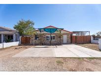 Charming home with a stone facade, a red roof, and a large concrete parking pad at 2445 W Yuma St, Phoenix, AZ 85009