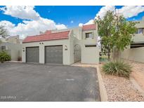 Charming townhome with two-car garage, terra cotta tile roof, and gated entry, near community lake at 2524 S El Paradiso -- # 122, Mesa, AZ 85202
