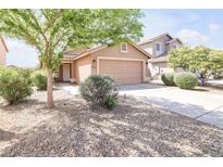 Charming single-story home featuring low-maintenance desert landscaping and a two-car garage at 41341 W Little Dr, Maricopa, AZ 85138