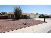 Charming single-story brick home with a well-maintained, low maintenance rock front yard at 4153 W Sunnyside Ave, Phoenix, AZ 85029