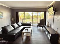 Inviting living room features a sliding glass door with scenic outdoor views and modern furnishings at 4750 N Central Ave # M2, Phoenix, AZ 85012