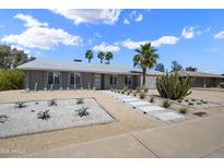 Charming single-story home featuring desert landscaping with a rock lawn, walkway, and large cactus at 4904 E Tierra Buena Ln, Scottsdale, AZ 85254