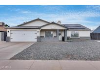 Charming single-story home with a well-maintained yard and a two-car garage on a beautiful sunny day at 5228 W Aster Dr, Glendale, AZ 85304