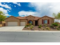 Charming single-story home featuring a well-manicured front yard and an attached two-car garage at 6125 E Hodges St, Cave Creek, AZ 85331