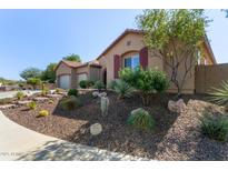 Landscaped front yard with desert flora and a charming stucco home with a two-car garage at 6125 E Hodges St, Cave Creek, AZ 85331