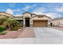 Charming single-Gathering home featuring a two-car garage, well-maintained landscaping, and a welcoming entrance at 6608 W Saguaro Park Ln, Glendale, AZ 85310