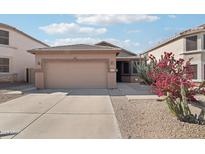 Charming single-story home featuring a desert landscape and a two-car garage at 6777 W Tether Trl, Peoria, AZ 85383
