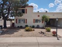 Charming home with desert landscaping, mature tree and covered parking at 7665 E Highland Ave, Scottsdale, AZ 85251