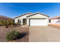 Charming single-story home featuring a two-car garage, landscaped front yard and neutral color palette at 8576 E Jasper St, Gold Canyon, AZ 85118