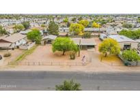 This is an aerial view of the home with mature trees, and ample parking space at 10437 E Boulder Dr, Apache Junction, AZ 85120