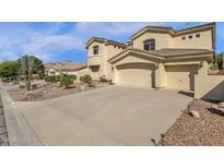 Stunning two-story home boasts a three-car garage and desert landscaping, showcasing curb appeal at 13827 N Mesquite Ln, Fountain Hills, AZ 85268