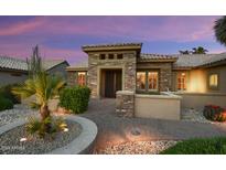 Inviting front exterior with desert landscaping and stone accents, showcasing a charming entrance at 15109 W Waterford Dr, Surprise, AZ 85374