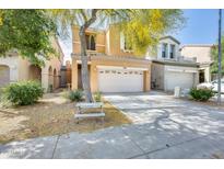 Charming two-story home showcasing a xeriscaped front yard with a mature tree providing shade at 1633 W Lacewood Pl, Phoenix, AZ 85045