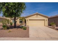 Charming single-story home with a desert landscape and a two-car garage at 20627 N Lemon Drop Dr, Maricopa, AZ 85138
