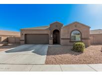 Charming single-story home with a two-car garage and desert landscaping for low maintenance at 23805 W Romley Ave, Buckeye, AZ 85326