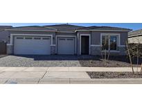 Charming single-story home with a three-car garage and landscaped front yard at 24152 N 172Nd Ave, Surprise, AZ 85387