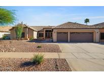 Charming single-story home featuring a well-maintained landscape, a two-car garage, and tile roofing at 2449 E Desert Flower Ln, Phoenix, AZ 85048