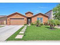 Charming single-story home with a well-manicured lawn, beautiful landscaping, and a two-car garage at 2468 W Dapple Gray Ct, San Tan Valley, AZ 85144