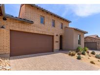 Charming home with a two-car garage, beautiful brickwork and a well-kept desert landscaped yard at 26699 N 104Th Way, Scottsdale, AZ 85262