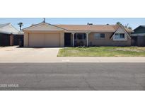 Charming single-story home with a well-manicured lawn, attached garage and classic suburban appeal at 3141 W Joan De Arc Ave, Phoenix, AZ 85029