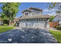 Charming two-story home with a three-car garage and manicured lawn at 3252 E Lexington Ave, Gilbert, AZ 85234