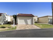 Charming single-story home with a two-car garage, tile roof, and well-manicured front lawn at 562 S Palo Verde Way, Mesa, AZ 85208