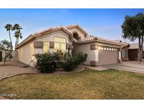 Charming single-story home with a well-maintained lawn, desert landscaping and a two-car garage at 763 E Park Ave, Chandler, AZ 85225