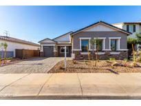 Charming single-story home with neutral paint, stone accents, and well-maintained landscaping at 11660 W Luxton Ln, Avondale, AZ 85323