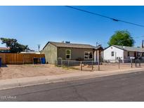 View of the exterior of the property with fence and gravel landscape at 1424 S Bonarden Ln, Tempe, AZ 85281