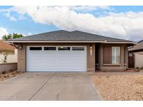 Charming single-story home featuring a two-car garage, desert landscaping, and a neutral color palette at 1736 E Villa Maria Dr, Phoenix, AZ 85022