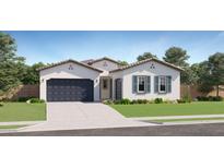 Inviting single-story home featuring a two-car garage and well-manicured lawn at 17551 W Victory St, Goodyear, AZ 85338