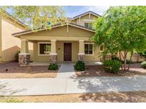 Charming two-story home featuring stone accents on the porch columns and a well-maintained front yard at 20733 W Alsap Rd, Buckeye, AZ 85396