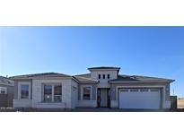Modern single-Gathering home featuring a light-colored stone facade, gray trim, and a two-car garage at 24170 N 172Nd Ave, Surprise, AZ 85387