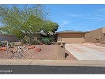 Charming single-story home featuring desert landscaping, a two-car garage, and a welcoming front entrance at 25639 S Beech Creek Dr, Sun Lakes, AZ 85248