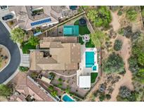 Expansive property with a sparkling pool, basketball court, and multiple patio areas, surrounded by lush landscaping at 30129 N 52Nd Pl, Cave Creek, AZ 85331
