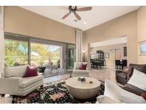 Open living area with neutral walls, ceiling fan, and sliding door to the backyard patio at 6094 E Evening Glow Dr, Scottsdale, AZ 85266