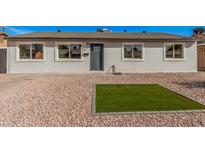 Charming single-story home with gray brick and a well-maintained xeriscaped front yard at 6823 W Coolidge St, Phoenix, AZ 85033