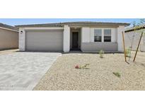Charming single-story home featuring a two-car garage and minimalist desert landscaping for low maintenance at 9543 W Parkway Dr, Tolleson, AZ 85353