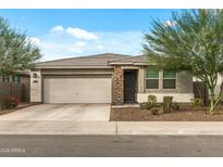 Charming single-story home with a well-maintained front yard and a two-car garage at 12374 W Locust Ln, Avondale, AZ 85323