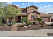 Charming two-story home with manicured desert landscaping, a spacious garage, and a welcoming front entrance at 18585 E Ryan Rd, Queen Creek, AZ 85142