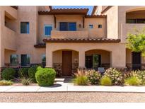 Inviting two-story townhome featuring a private front porch and landscaped yard with beautiful flowers at 2821 S Skyline -- # 135, Mesa, AZ 85212