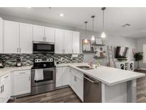 Well-lit kitchen with white cabinets, stainless steel appliances, and decorative backsplash at 2821 S Skyline -- # 135, Mesa, AZ 85212