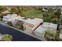 Stunning aerial view of a modern home on golf course with a flat roof, and a two-car garage at 3033 E Claremont Ave, Phoenix, AZ 85016