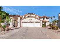 Charming two-story home showcasing a three-car garage, landscaped yard and a classic Southwest style at 3112 N 110Th Ave, Avondale, AZ 85392