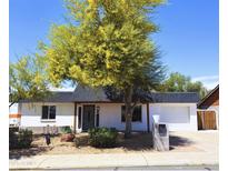 Charming single-story home featuring desert landscaping, a black roof, and a cozy covered entryway at 3514 W Altadena Ave, Phoenix, AZ 85029
