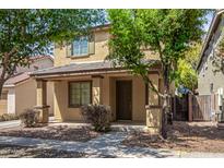 Beautiful two-story home with covered porch, lush front yard and stone accents at 3552 E Carla Vista Dr, Gilbert, AZ 85295